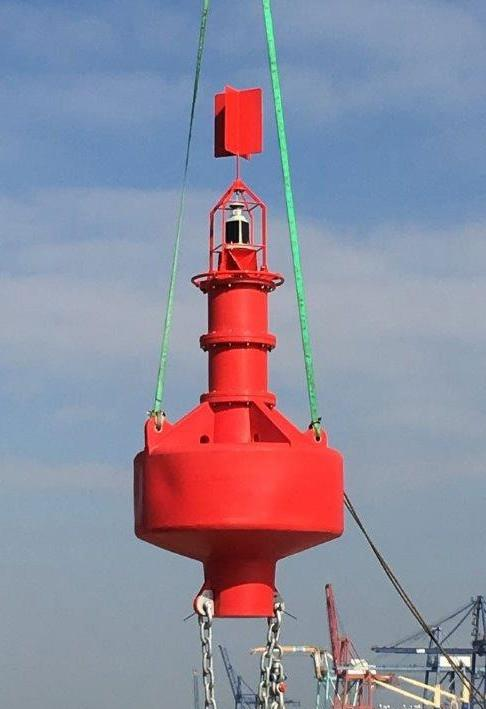 Red polyethylene navigation buoy in open water