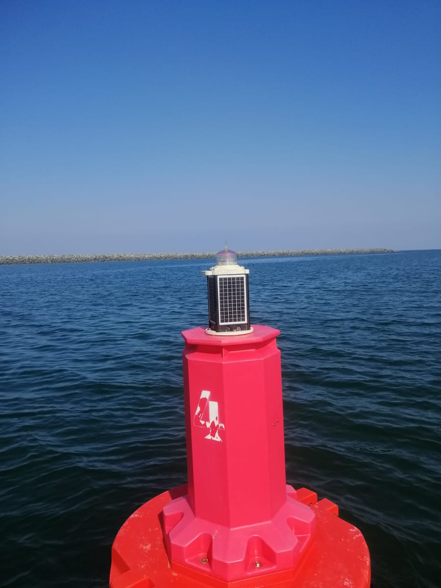 Red navigation buoy with top mark and lantern
